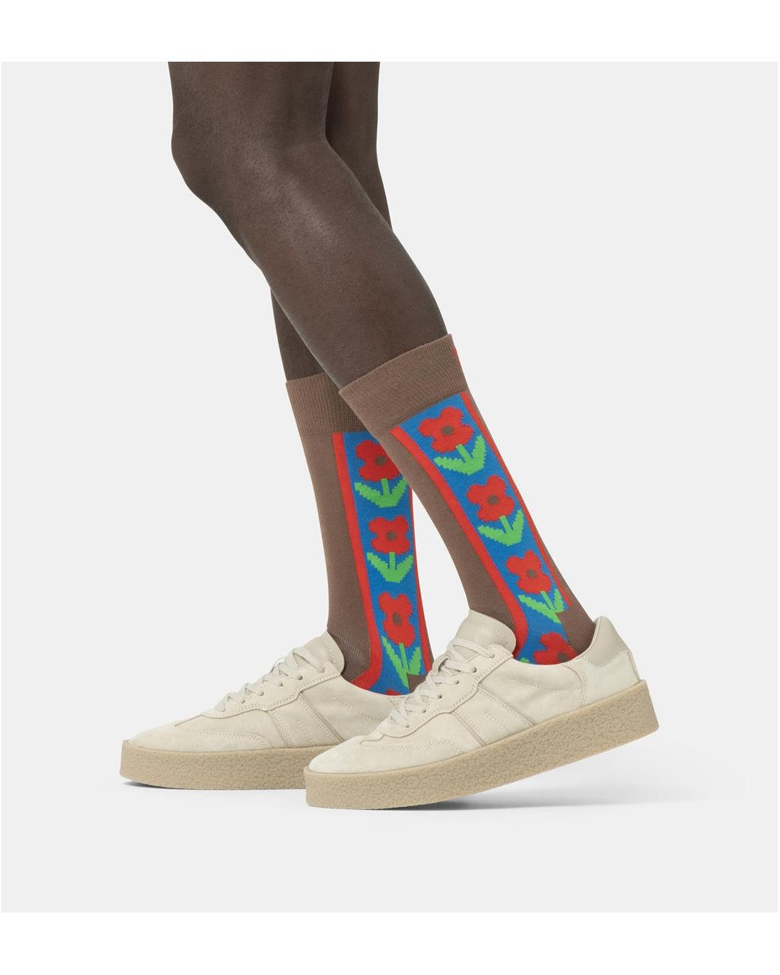 Happy Socks γυναικείες καφέ κάλτσες Vertical Flowers με κόκκινα λουλούδια μέσα σε μπλε κάθετη ρίγα με κόκκινο περίγραμμα, φορεμένες.