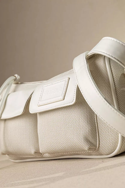 Κοντινή λήψη των εξωτερικών τσεπών του εκρού τσαντακιού FRAGOLA που δείχνει τη λειτουργικότητα